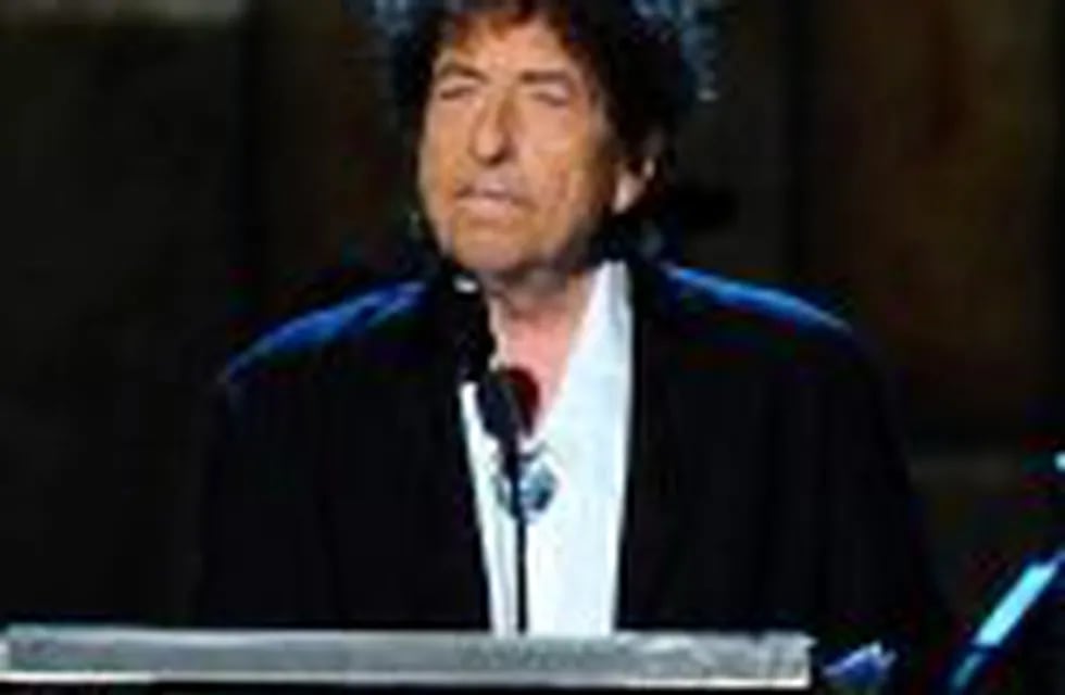 FILE - In this Feb. 6, 2015 file photo, Bob Dylan accepts the 2015 MusiCares Person of the Year award at the 2015 MusiCares Person of the Year show in Los Angeles.  The Swedish Academy says Dylan is not coming to Stockholm to pick up his 2016 Nobel Prize for literature at the Dec. 10, 2016 prize ceremony.  (Photo by Vince Bucci/Invision/AP, File)