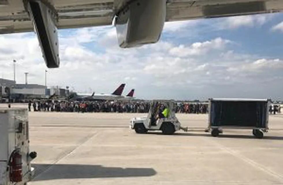 Photo courtesy of Taylor Elenburg shows Passengers gathering on the tarmac of the Fort Lauderdale-Hollywood airport in Florida after a gunman opened fire on January 06, 2017. nA gunman opened fire Friday at Fort Lauderdale-Hollywood airport in Florida, ca