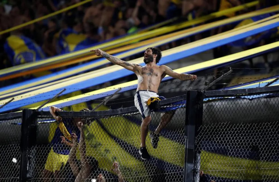 A fan of Boca Juniors celebrates after his team defeated 1-0 Gimnasia y Esgrima to win Argentina's Superliga soccer tournament at La Bombonera stadium in Buenos Aires, Argentina, Saturday, March 7, 2020. (AP Photo/Natacha Pisarenko)