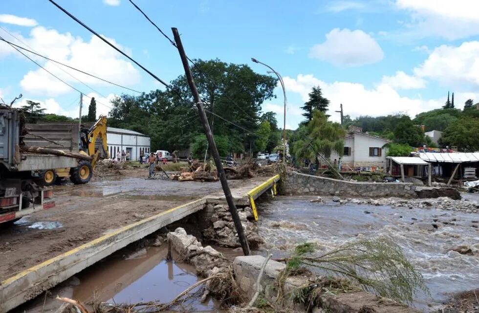 Residents stand near a ruined road after floods affected the Cordoba province February 16, 2015. Seven people were found dead and more than 1,000 evacuees have not been able to return to their homes after several rivers flooded the Cordoba province on Sunday, following the heavy rains which hit the region, governor Jose Manuel de la Sota said. REUTERS/Dario Giana (ARGENTINA - Tags: DISASTER) villa allende cordoba  cordoba desastres naturales inundaciones inundada zona de Sierras Chicas es el peor desastre en los ultimos 20 años