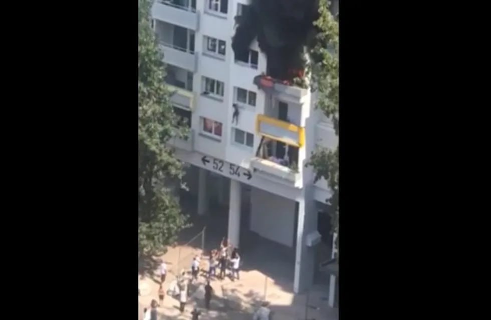 In this grab taken from video, a boy jumps from a window as flames engulfed an apartment as onlookers below prepare to catch him, in Grenoble, France, Tuesday, July 21, 2020. A boy and a toddler escaped a blaze at an apartment in the southeastern French city of Grenoble on Tuesday after they jumped into the arms of residents. The two brothers, aged three and 10 years old, were hanging from a window as flames engulfed their home and onlookers below screamed for them to jump down. (AP)