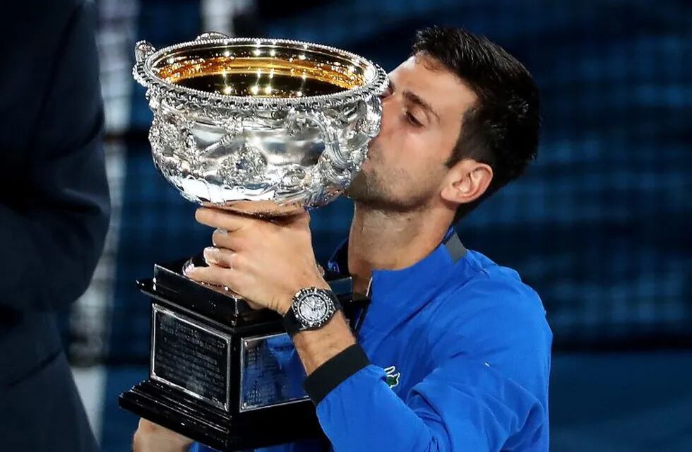 27/01/2019 27 January 2019, Australia, Melbourne: Serbian tennis player Novak Djokovic kisses the trophy after winning his men's singles final match against Spanish Rafael Nadal, on day fourteen of the Australian Open tennis tournament. Photo: David Crosling/AAP/dpa DEPORTES David Crosling/AAP/dpa