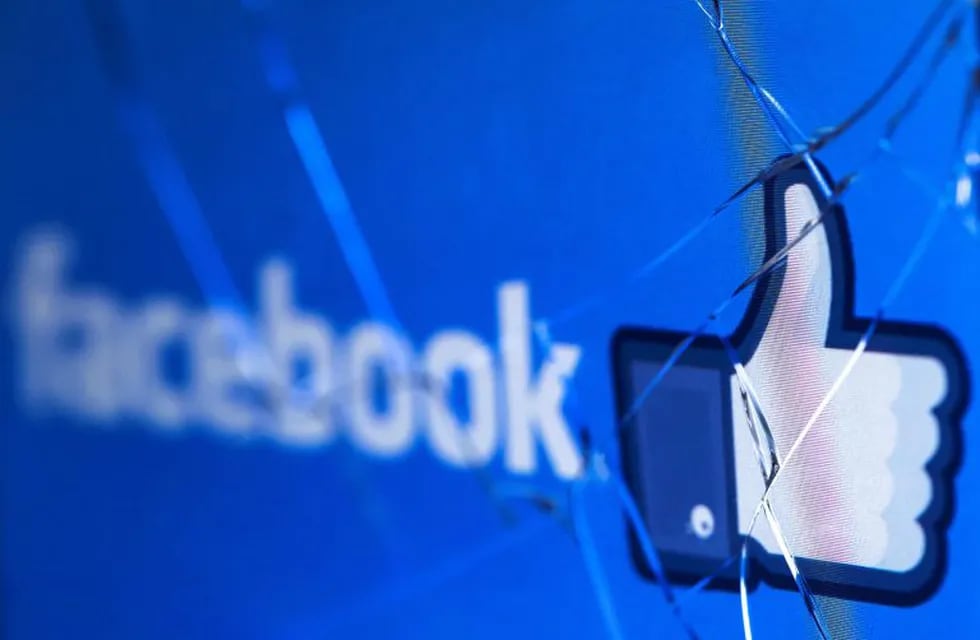 (FILES) In this file photo taken on May 16, 2018 shows the logo of the social network Facebook on a broken screen of a mobile phone. - Facebook said Thursday, November 15, 2018 it was severing ties with a political consultancy that sought to discredit critics of the social networking giant using questionable campaign-style tactics. The California-based company's announcement followed a lengthy New York Times investigation detailing Facebook's struggles with its image as it came under scrutiny for its handling of Russian-led misinformation efforts. Facebook said in a statement that \