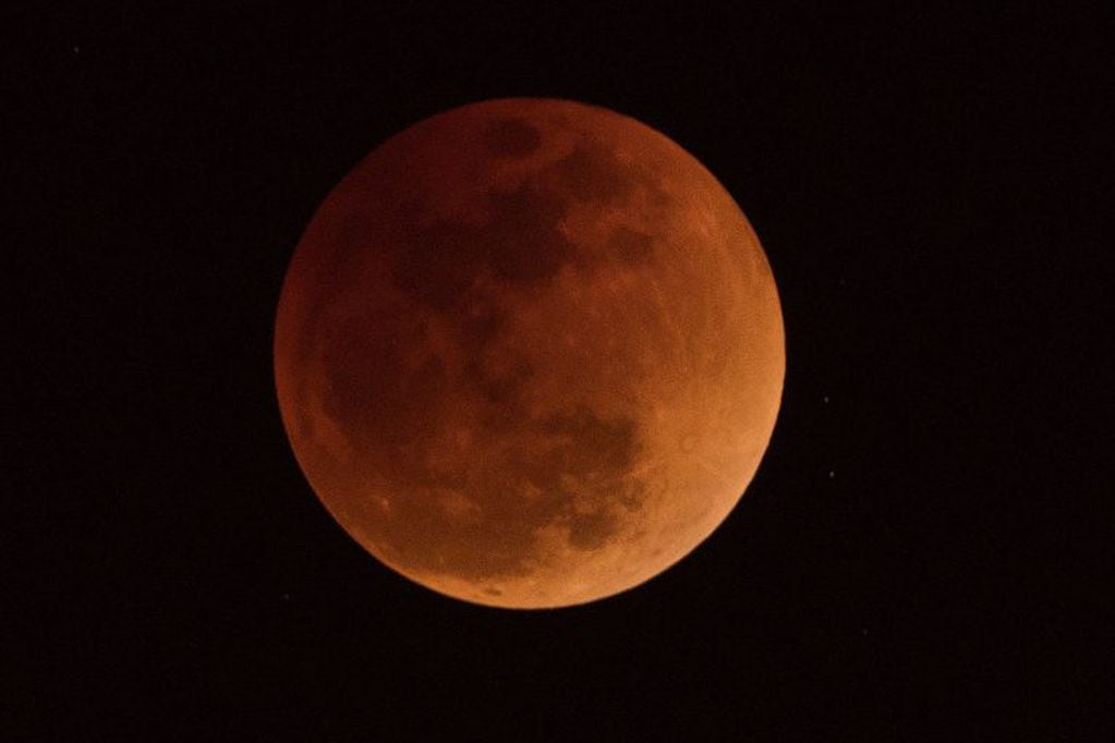 The moon is seen during a lunar eclipse, referred to as the "super blue blood moon", in Beijing on January 31, 2018.
Skywatchers were hoping for a rare lunar eclipse that combines three unusual events -- a blue moon, a super moon and a total eclipse -- which was to make for a large crimson moon viewable in many corners of the globe. / AFP PHOTO / NICOLAS ASFOURI