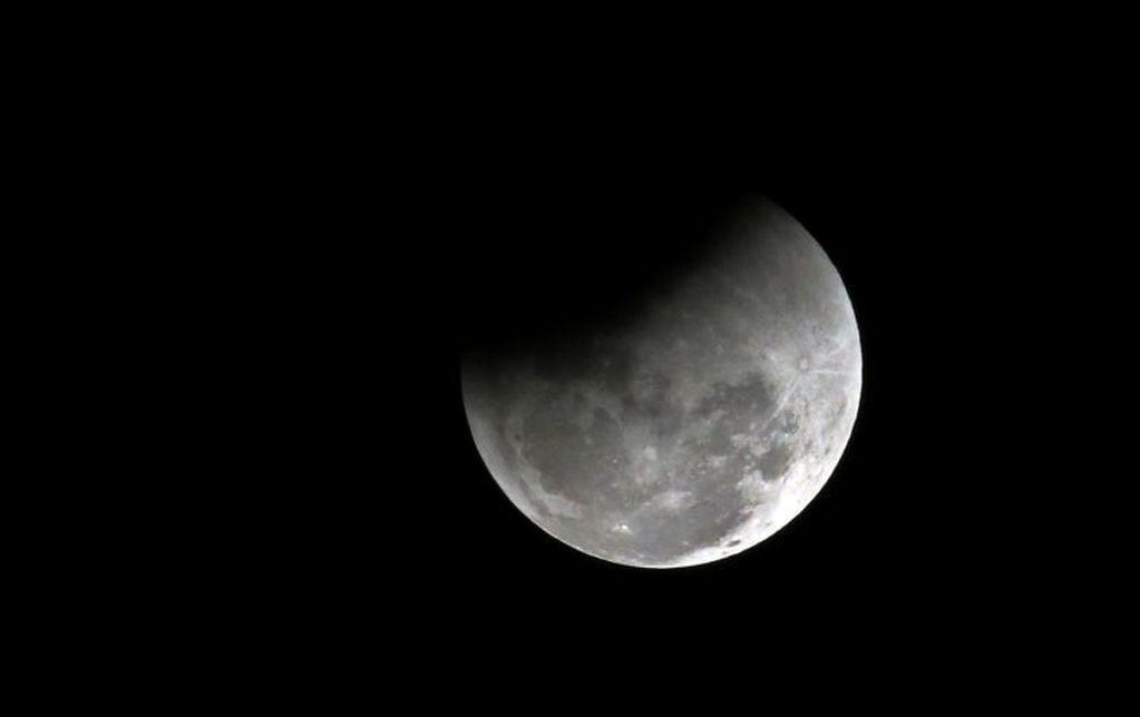 The moon passes into the earth's shadow during a lunar eclipse as seen in Bangalore, India, Wednesday, Jan. 31, 2018. The moon is putting on a rare cosmic show. It's the first time in 35 years a blue moon has synced up with a supermoon and a total lunar eclipse. NASA is calling it a lunar trifecta: the first super blue blood moon since 1982. That combination won't happen again until 2037. (AP Photo/Aijaz Rahi)