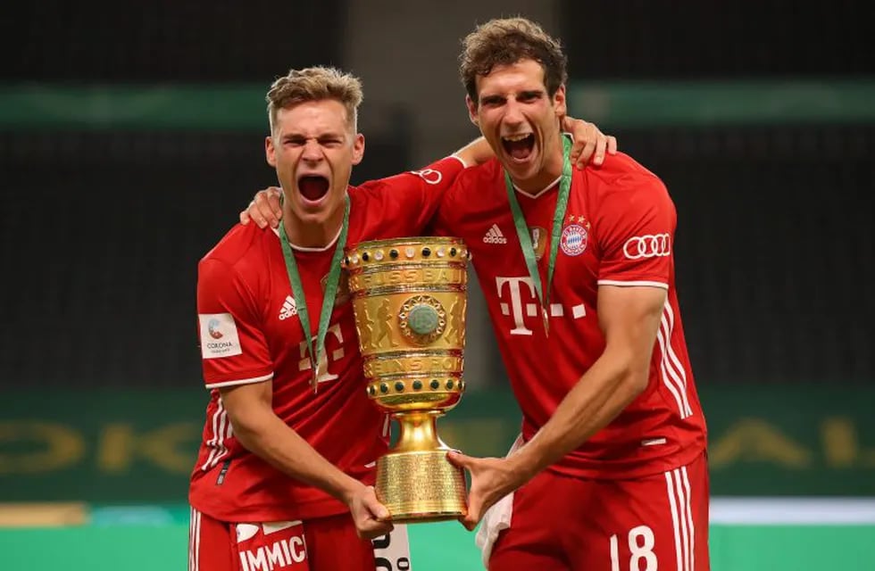 Bayern Munich's German midfielder Joshua Kimmich (L) and Bayern Munich's German midfielder Leon Goretzka celebrate with the German Cup (DFB Pokal) trophy after winning the final football match Bayer 04 Leverkusen v FC Bayern Munich at the Olympic Stadium in Berlin on July 4, 2020. (Photo by Alexander Hassenstein / POOL / AFP) / DFB REGULATIONS PROHIBIT ANY USE OF PHOTOGRAPHS AS IMAGE SEQUENCES AND QUASI-VIDEO.