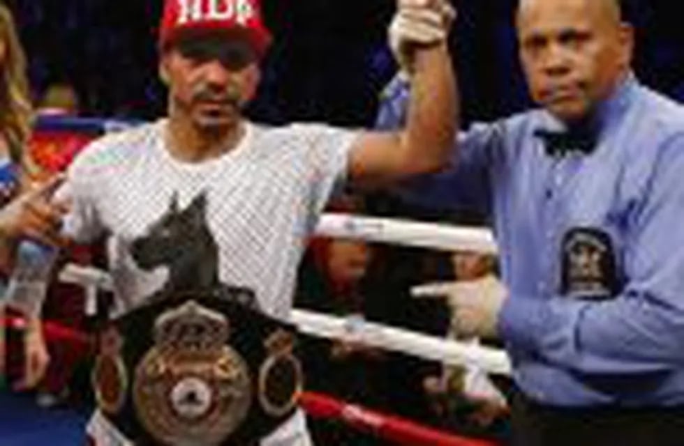 Jesus Cuellar, of Argentina, has his arm raised by referee Ricky Gonzalez after defeating Jonathan Oquendo, of Puerto Rico, by a unanimous decision during a WBA featherweigh championship boxing bout in New York on Saturday, Dec. 5, 2015. (AP Photo/Rich Sc