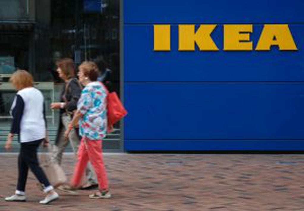 Pedestrians pass a logo outside an Ikea AB high street store in Hamburg, Germany, on Monday, Aug. 4, 2014. Ikea opened its first city-center store in the district of Altona, the most westerly of Hamburg's seven boroughs, in a pilot project targeting a ris