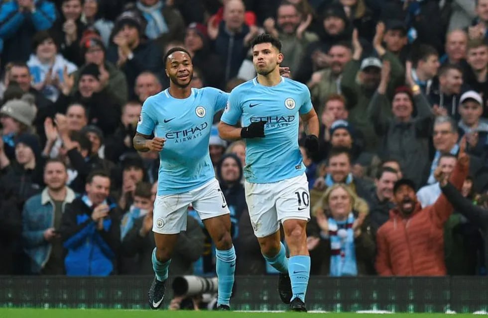 Manchester City's Argentinian striker Sergio Aguero (R) celebrates scoring the opening goal during the English Premier League football match between Manchester City and Bournemouth at the Etihad Stadium in Manchester, north west England, on December 23, 2017. / AFP PHOTO / Oli SCARFF / RESTRICTED TO EDITORIAL USE. No use with unauthorized audio, video, data, fixture lists, club/league logos or 'live' services. Online in-match use limited to 75 images, no video emulation. No use in betting, games or single club/league/player publications.  /
