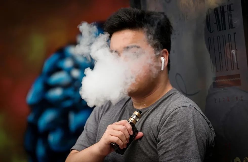 A person exhales vapor while using an electronic cigarette device in San Francisco, California, U.S., on Monday, June 24, 2019. The city will hold a final vote Tuesday to ban sales of e-cigarettes, making it illegal to sell nicotine vaporizer products in stores or for online retailers to ship the goods to San Francisco addresses. Photographer: David Paul Morris/Bloomberg