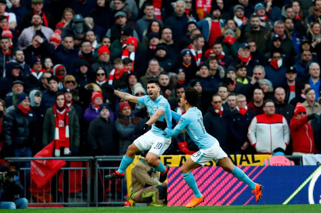 Manchester City's Argentinian striker Sergio Aguero celebrates with Manchester City's German midfielder Leroy Sane (R) after scoring the opening goal during the English League Cup final football match between Manchester City and Arsenal at Wembley stadium in north London on February 25, 2018. / AFP PHOTO / Adrian DENNIS / RESTRICTED TO EDITORIAL USE. No use with unauthorized audio, video, data, fixture lists, club/league logos or 'live' services. Online in-match use limited to 75 images, no video emulation. No use in betting, games or single club/league/player publications.  /