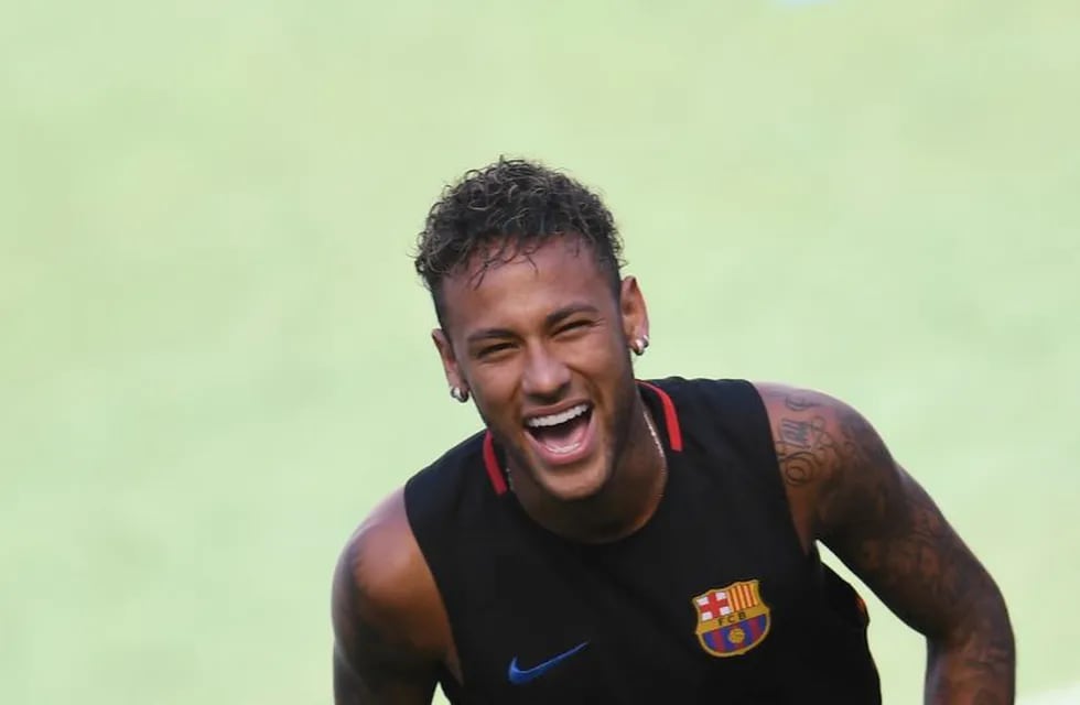 (FILES) This file photo taken on July 22, 2017 at the Red Bull Arena in Harrison shows Barcelona's Brazilian forward Neymar smiling during a training session.\nNeymar is expected to arrive in Paris on August 3, 2017 to finalise his world record 222 million euro ($260 million) move from Barcelona to Paris Saint-Germain, which will earn him around 30 million euros ($35.5 million) a year. / AFP PHOTO / Jewel SAMAD