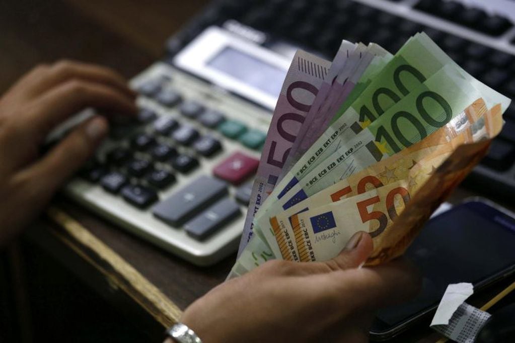Un trabajador cuenta billetes de euro. EFE/Arshad Arbab