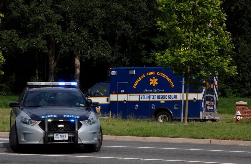 An ambulance turns on Nimmo Parkway following a shooting at the Virginia Beach Municipal Center on Friday, May 31, 2019, in Virginia Beach, Va. At least one shooter wounded multiple people at a municipal center in Virginia Beach on Friday, according to police, who said a suspect has been taken into custody. (Kaitlin McKeown/The Virginian-Pilot via AP)