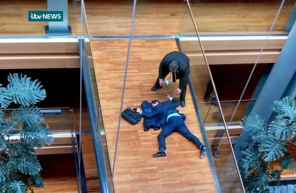 British UK Independence Party Member of the European Parliament Steven Woolfe lies on the ground  after losing consciousness in the European Parliament building in Strasbourg France Thursday Oct. 6, 2015.  Britain's fractious, right-wing U.K. Independence Party erupted into violence Thursday that left Steven Woolfe  hospitalized with a head injury after an 