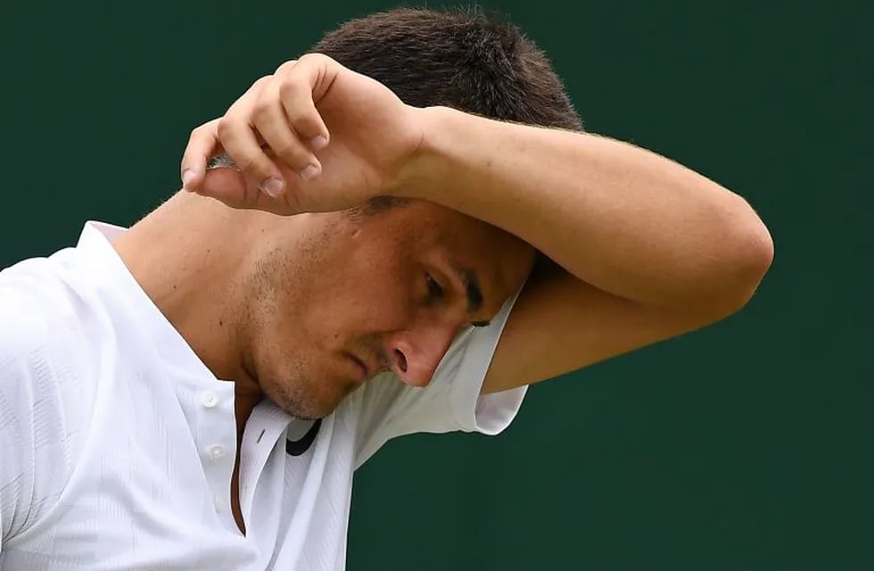 (FILES) A file photo taken on July 4, 2017, shows Australia's Bernard Tomic reacting against Germany's Mischa Zverev during their men's singles first round match on the second day at 2017 Wimbledon Championships in London.\nApathetic Australian star Bernard Tomic has admitted he is playing tennis just for the money and says he has no love for the game that has earned him millions. In a frank Australian television interview on July 23 July, Tomic told his fans to stay at home rather than paying to watch him play if they were opposed to his polarising on-court antics.\n / AFP PHOTO / JUSTIN TALLIS / -- IMAGE RESTRICTED TO EDITORIAL USE - STRICTLY NO COMMERCIAL USE --