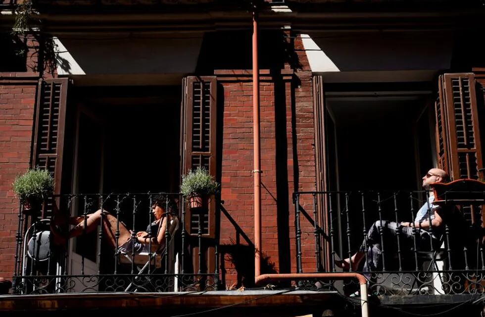 People sunbathe on their balconies, amid the coronavirus disease (COVID-19) outbreak in Madrid, Spain, May 20, 2020. REUTERS/Juan Medina