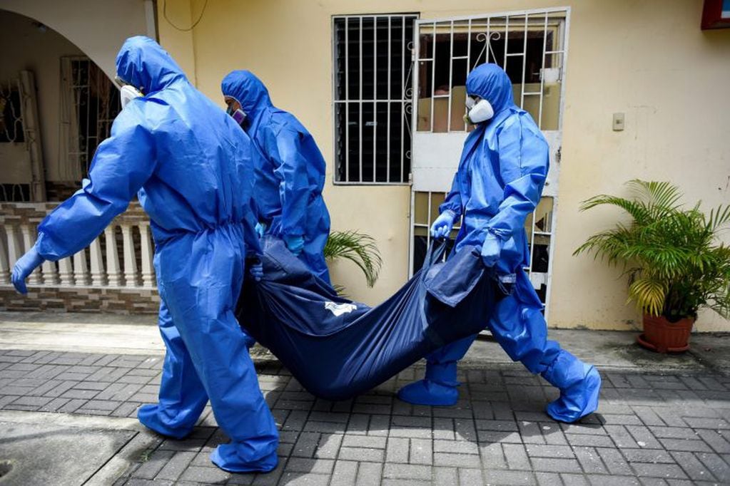Fotografía de archivo fechada el pasado 17 de abril de 2020 en la que miembros de la Fuerza de Tarea Conjunta (FTC) recolectan cadáveres en medio de la pandemia de la COVID-19 en Guayaquil (Ecuador). EFE/ Mauricio Torres