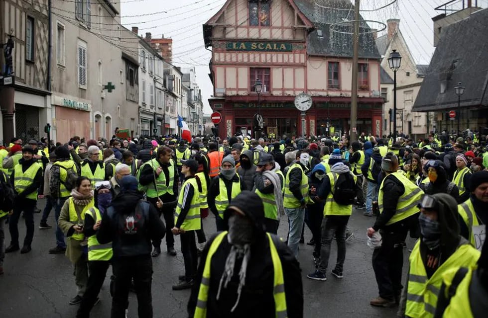 Yellow vest protesters demonstrate in Bourges, central France, Saturday, Jan. 12, 2019. Paris brought in armored vehicles and the central French city of Bourges shuttered shops to brace for new yellow vest protests. The movement is seeking new arenas and new momentum for its weekly demonstrations. Authorities deployed 80,000 security forces nationwide for a ninth straight weekend of anti-government protests. (AP Photo/Rafael Yaghobzadeh)