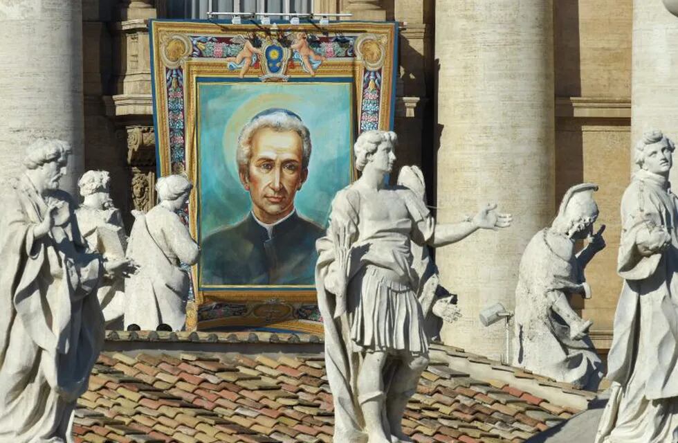 A tapestry hanged on the facade of St Peter's basilica shows a portrait of Italian Lodovico Pavoni during a canonization mass led by Pope Francis on October 16, 2016 at St Peter's square in Vatican. Pope Francis canonises Argentine 