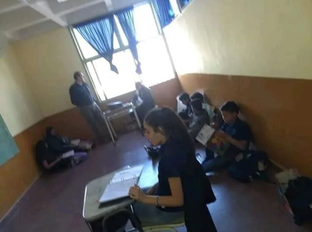 Alumnos de primer año sentados en el suelo por falta de bancos (El Ancasti).