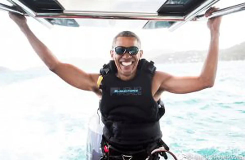 In this recent but undated photo made available by Virgin.com, former U.S President Barack Obama prepares to kitesurf during his stay on Moskito Island, British Virgin Islands. The former president and his wife stayed on Mosikto Island owned by Richard Br