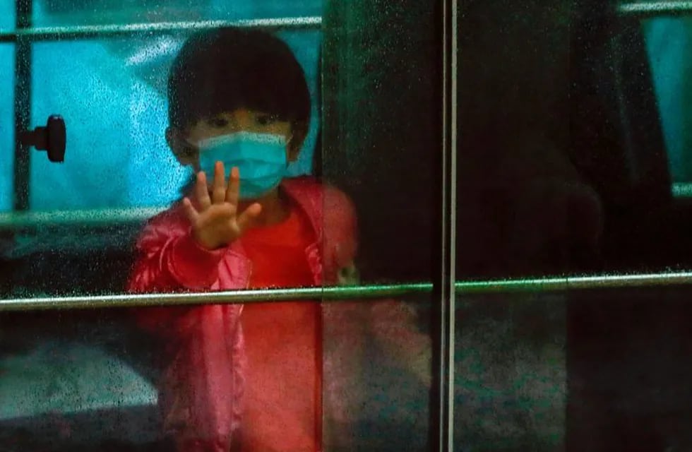 A child waves as she sits in a vehicle carrying residents evacuated from a public housing building, following the outbreak of the novel coronavirus, outside Hong Mei House, at Cheung Hong Estate in Hong Kong, China February 11, 2020. REUTERS/Tyrone Siu     TPX IMAGES OF THE DAY