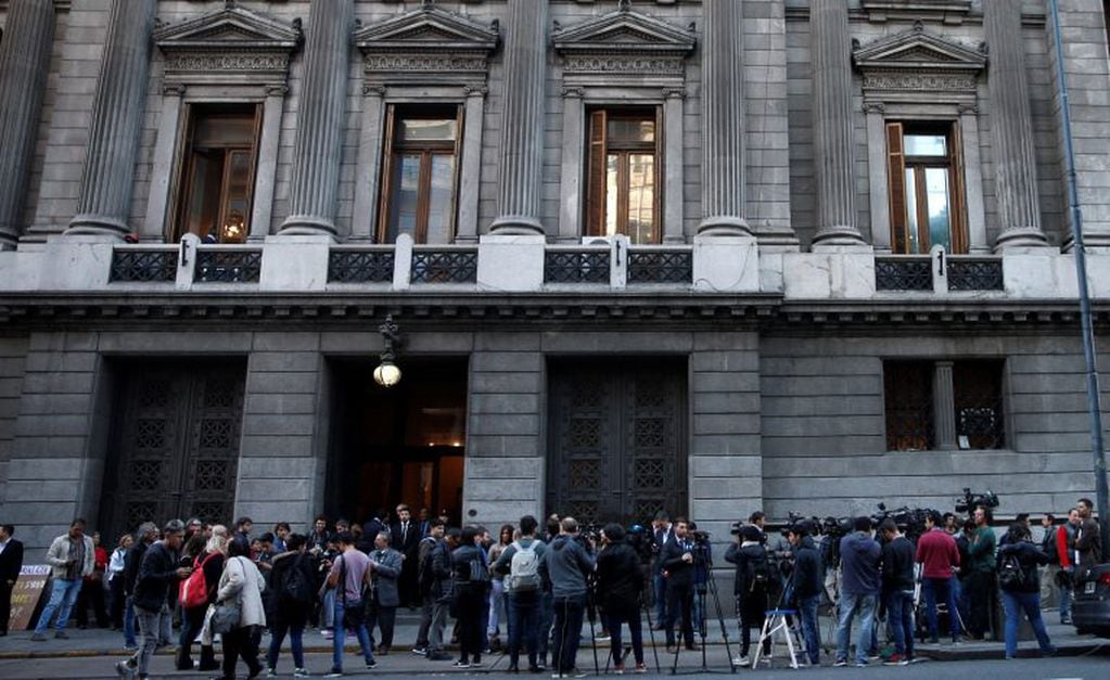 Journalists stand outside Congress where a wake for late lawmaker Hector Olivares is being held in Buenos Aires, Argentina, Monday, May 13, 2019. Olivares died three days after being seriously wounded in a May 9 gun attack that also killed a provincial official. (AP Photo/Natacha Pisarenko)