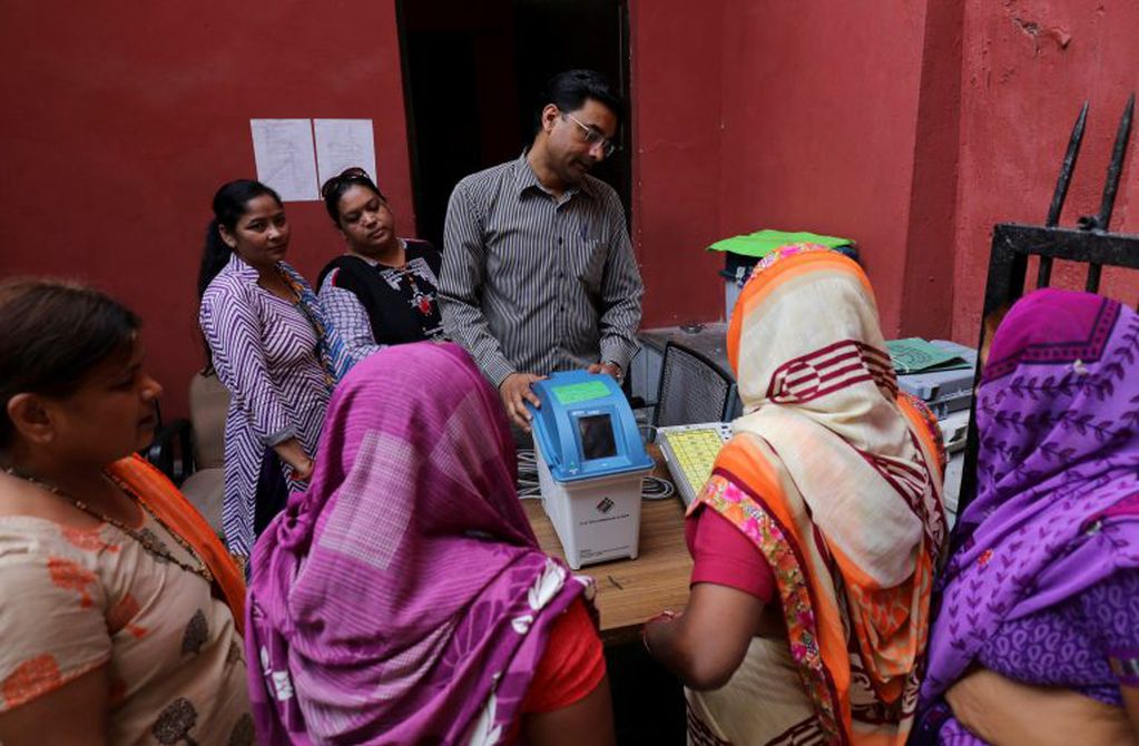 Las mujeres prestan atención a la demostración de las máquinas de votación electrónicas