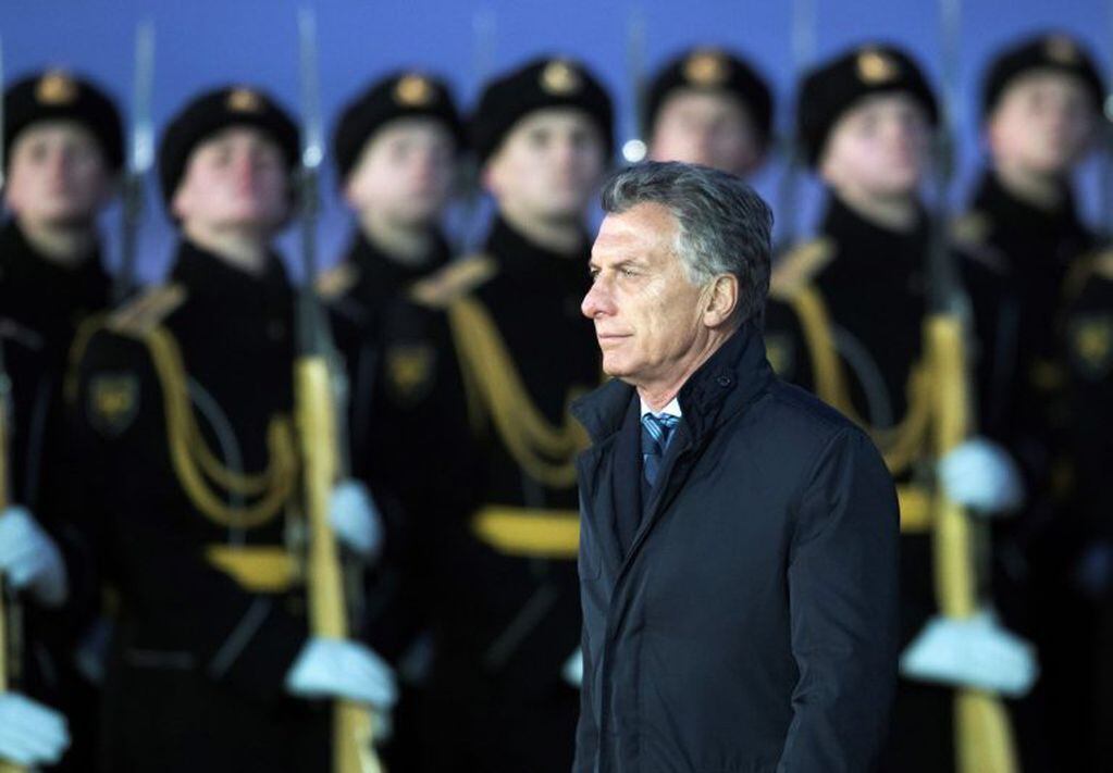 Argentina's President Mauricio Macri reviews a honour guards upon arrival in Moscow's Government Vnukovo airport for official visit to Russia in Moscow, Russia, Monday, Jan. 22, 2018. (AP Photo/Pavel Golovkin)