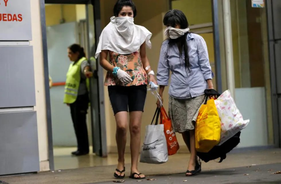 People cover their faces while leaving Hospital Cosme Argerich, after the first fatality from coronavirus in Latin America was confirmed, in Buenos Aires, Argentina March 7, 2020. REUTERS/ Mariana Greif