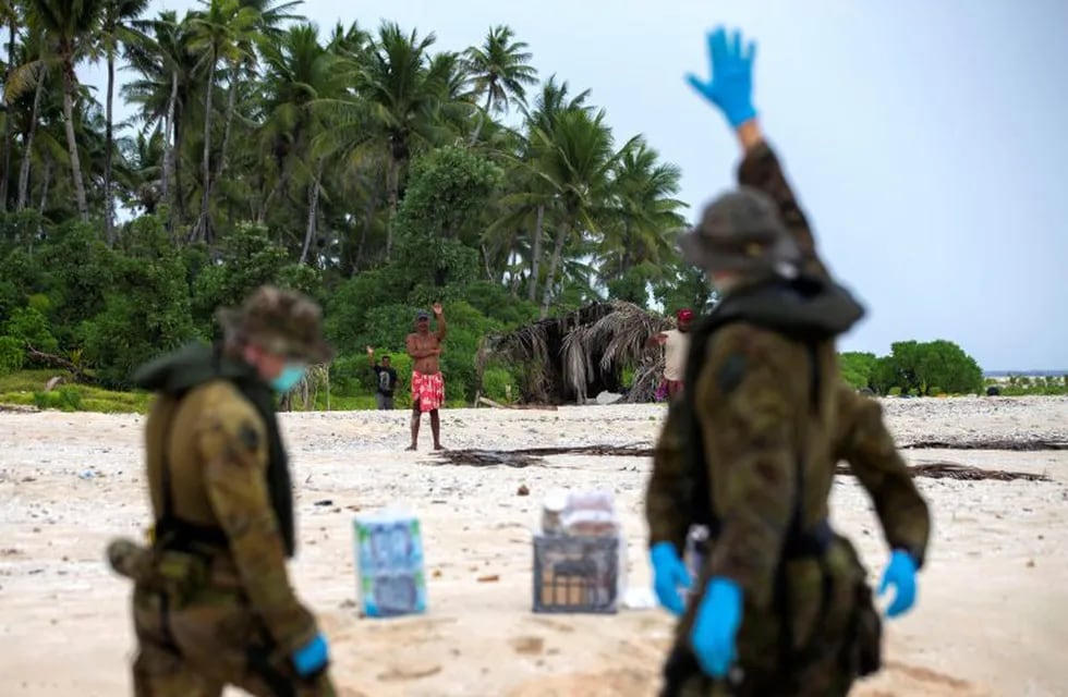 In this photo provided by the Australian Defence Force, an Australian Army helicopter lands on Pikelot Island in the Federated States of Micronesia where three men were found, Sunday, Aug. 2, 2020, safe and healthy after missing for three days. The men were missing in the Micronesia archipelago east of the Philippines for nearly three days when their \