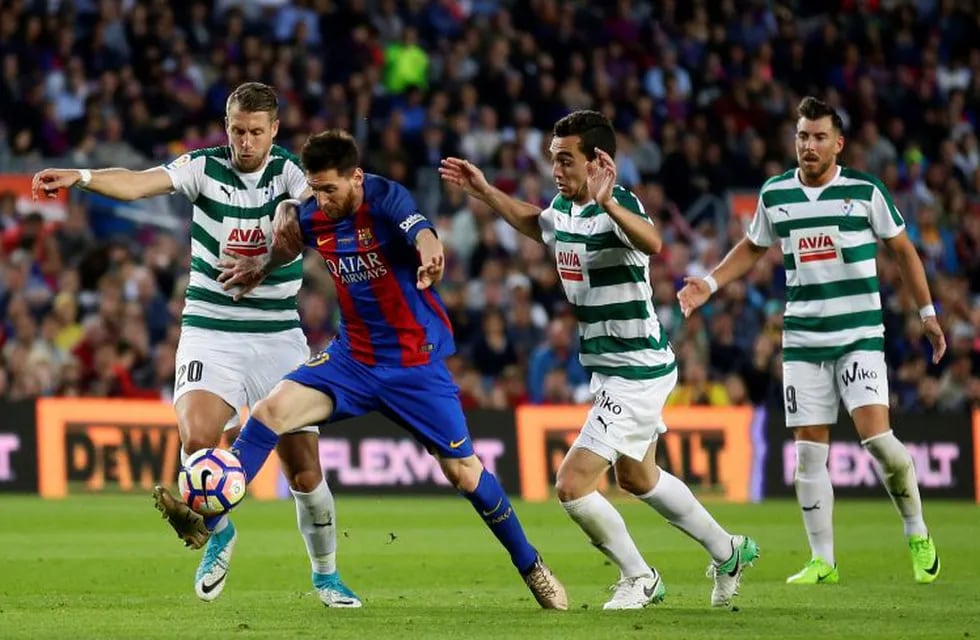 FC Barcelona's Lionel Messi, second left, duels for the ball during the Spanish La Liga soccer match between FC Barcelona and Eibar at the Camp Nou stadium in Barcelona, Spain, Sunday, May 21, 2017. (AP Photo/Manu Fernandez)