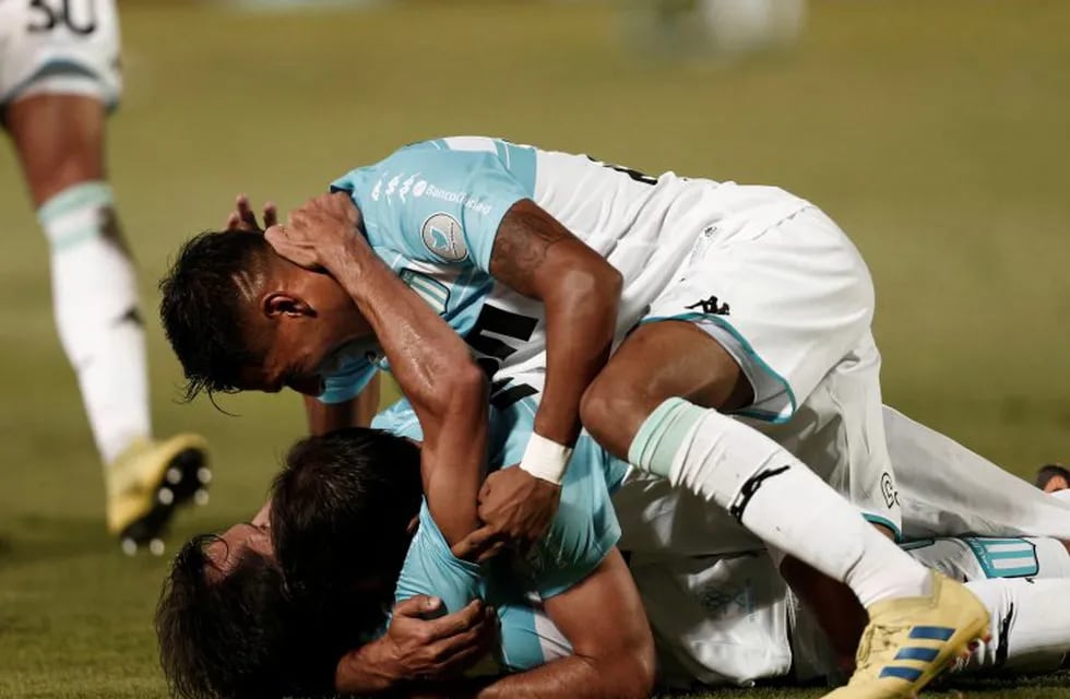 Racing Club's midfielder Augusto Solari celebrates with his teammates after scoring against Tigre during an Argentine Superliga soccer match in Victoria, on the outskirts of Buenos Aires, Argentina, Sunday, Mar. 31, 2019. (AP Photo/Mariano Blanc)