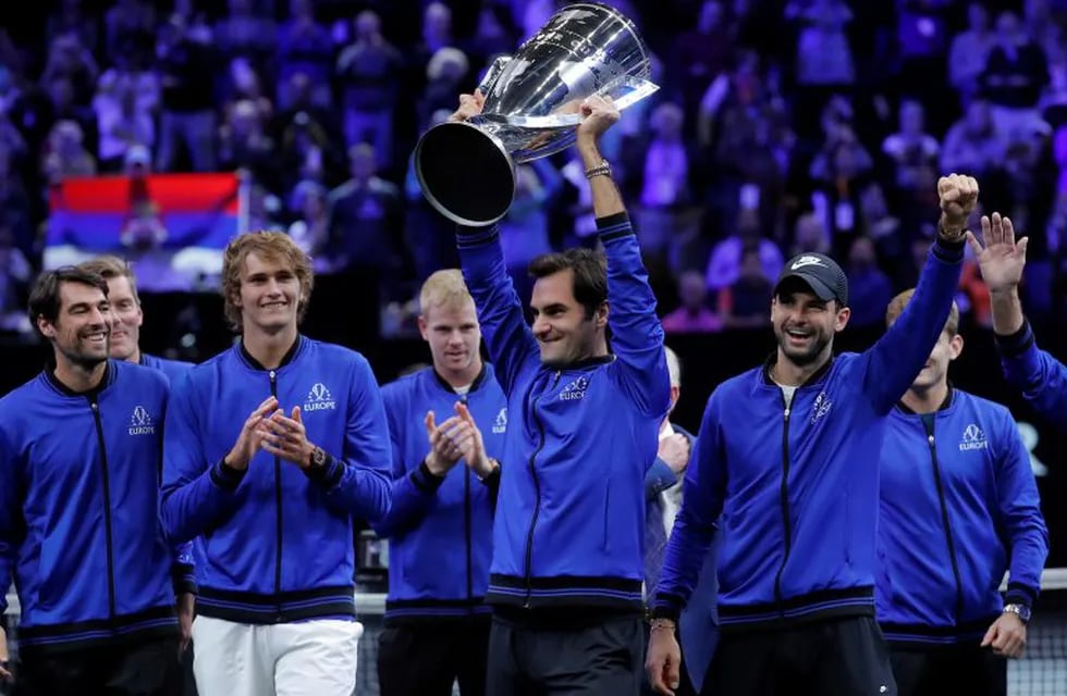 Team Europe's Roger Federer hoists the Laver Cup as he celebrates with teammates after defeating Team World in the Laver Cup tennis tournament, Sunday, Sept. 23, 2018, in Chicago. (AP Photo/Jim Young)