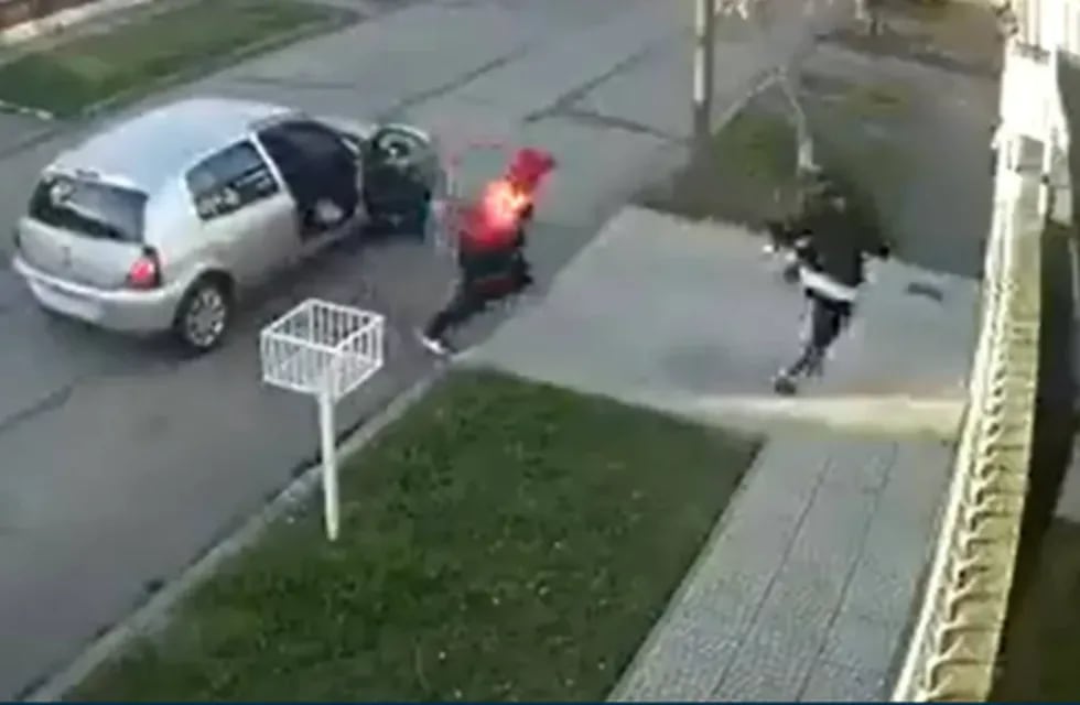 El momento exacto en el que uno de los delincuentes está por meterse dentro de la casa. Captura de video.