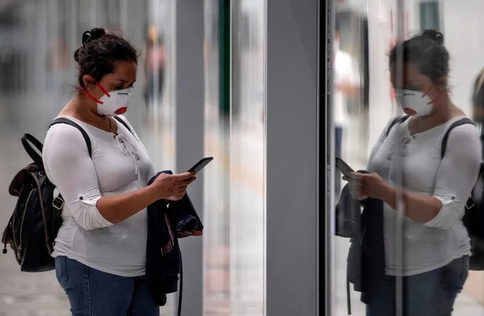 A commuter wears a face mask in a subway station in Santiago as a precautionary measure against the spread of the new coronavirus, COVID-19, on April 8, 2020. - The Chilean government decreed on Monday the mandatory use of face masks on all public transport, following the new recommendations of the World Health Organization (WHO). (Photo by Martin BERNETTI / AFP)