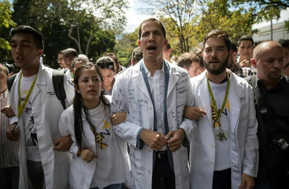 Opposition National Assembly President Juan Guaido, who declared himself interim president of Venezuela, takes part in a walk out against President Nicolas Maduro, in Caracas, Venezuela, Wednesday, Jan. 30, 2019. Venezuelans are exiting their homes and workplaces in a walkout organized by the opposition to demand that Maduro leave power. (AP Photo/Rodrigo Abd)
