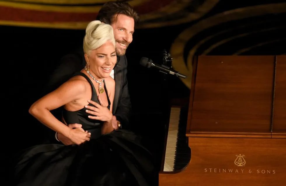 Lady Gaga, left, and Bradley Cooper react to the audience after a performance of \