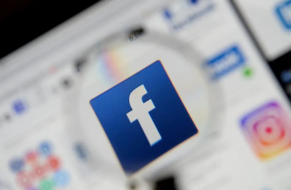 FILE PHOTO: The Facebook logo is seen on a screen in this picture illustration taken December 2, 2019. REUTERS/Johanna Geron/Illustration/File Photo
