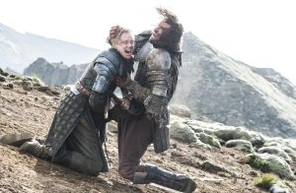 In this image released by HBO, Brienne of Tarth, portrayed by Gwendoline Christie, left, battles with  Sandor 