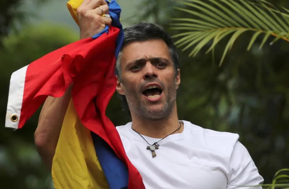 FILE - In this Saturday, July 8, 2017, file photo, Venezuela's opposition leader Leopoldo Lopez holds a national flag as he greets supporters outside his home in Caracas, Venezuela, following his release from prison and being placed under house arrest after more than three years in military lockup. Allies of two Venezuelan opposition leaders say Lopez and Antonio Ledezma have been taken by authorities from the homes where they were under house arrest. Video posted on the Twitter account of Lopez's wife early Tuesday, Aug. 1, shows a man being taken away from a Caracas home by state security agents. (AP Photo/Fernando Llano, File)