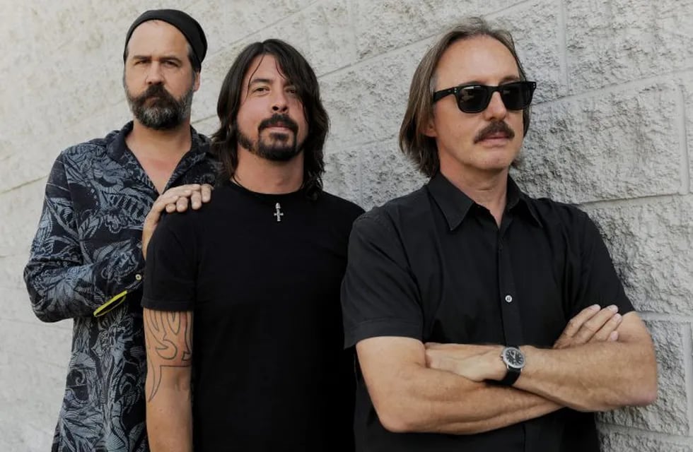 In this Sept. 6, 2011 photo, Krist Novoselic, left, and Dave Grohl, center, former members of the band Nirvana, pose with Butch Vig, producer of the band's landmark 1991 album \