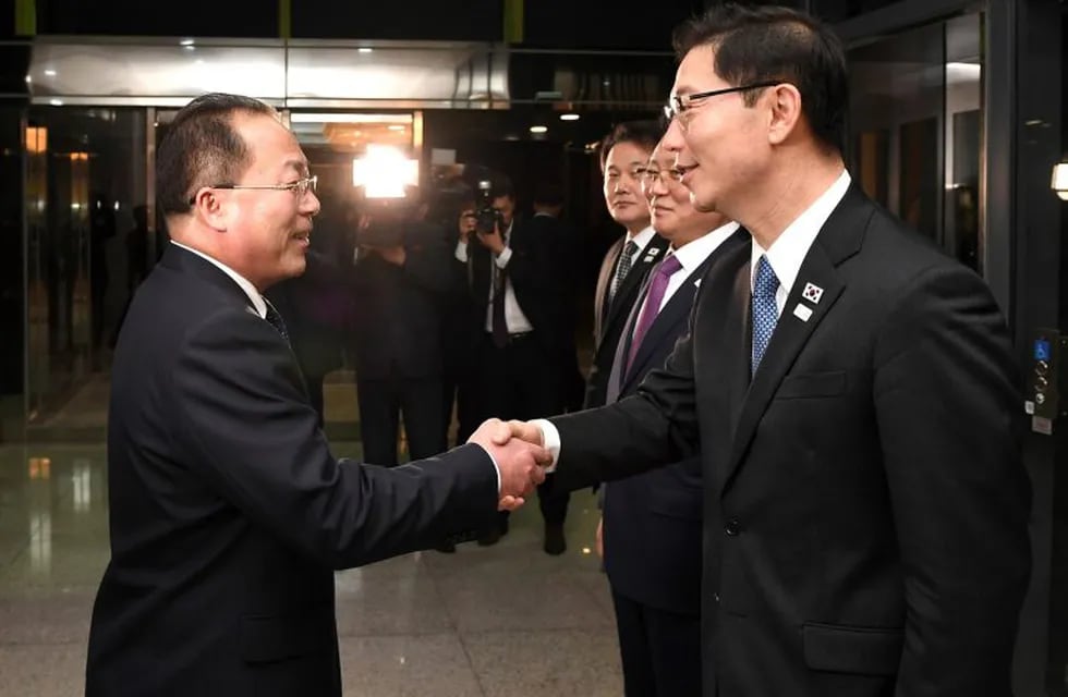 In this photo provided by South Korea Unification Ministry, South Korean Vice Unification Minister Chun Hae-sung, right, shakes hands with the head of North Korean delegation Jon Jong Su after a meeting at Panmunjom in the Demilitarized Zone in Paju, South Korea, Wednesday, Jan. 17, 2018. The rival Koreas agreed Wednesday to form their first unified Olympic team and have their athletes parade together during the opening ceremony of next month's Winter Olympics in the South, Seoul officials said. (South Korea Unification Ministry via AP)
