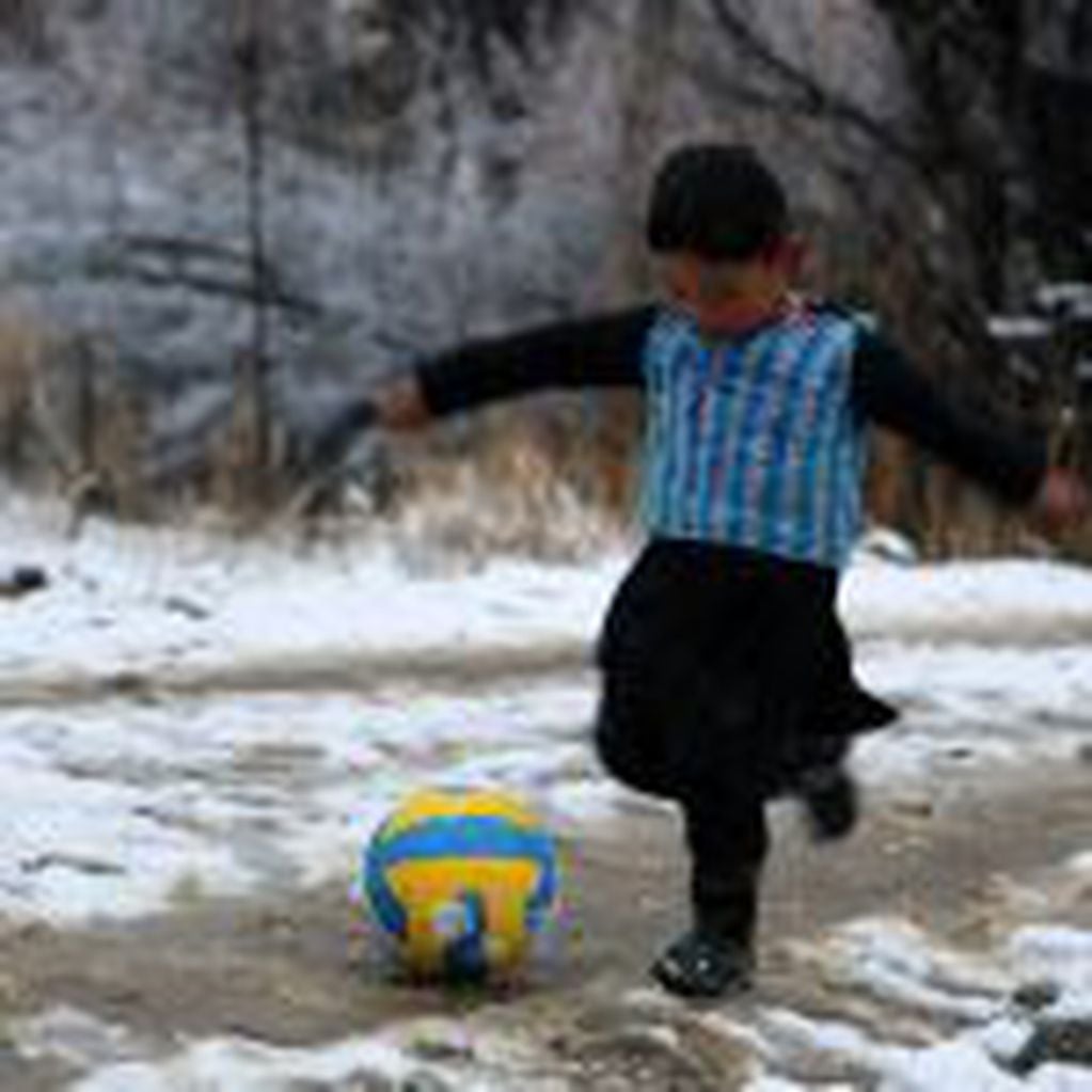 AFP PICTURES OF THE YEAR 2016
In this photograph taken on January 29, 2016, Afghan boy and Lionel Messi fan Murtaza Ahmadi, 5, wears a plastic bag jersey as he plays football in Jaghori district of Ghazni province.  A five-year-old Afghan boy has become a