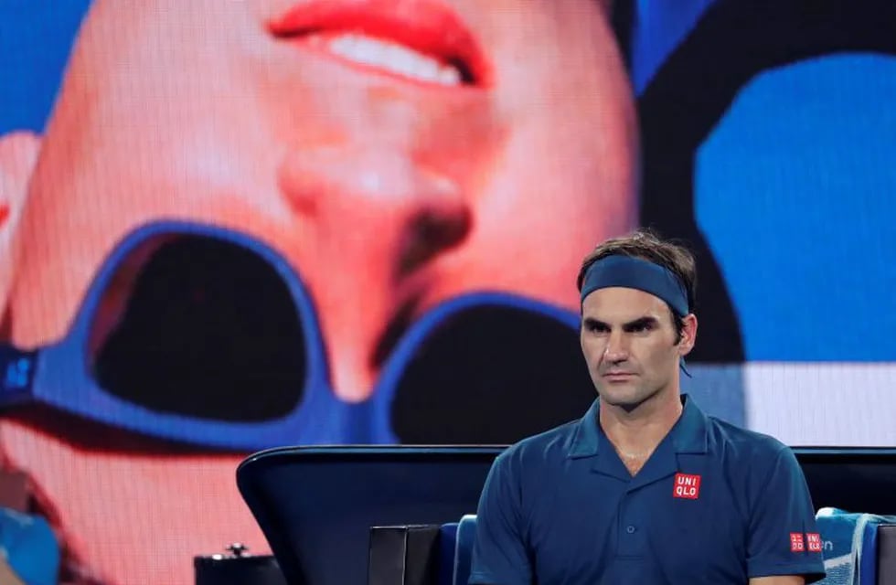 Switzerland's Roger Federer waits in his chair during a break in his third round match against United States' Taylor Fritz at the Australian Open tennis championships in Melbourne, Australia, Friday, Jan. 18, 2019. (AP Photo/Kin Cheung)