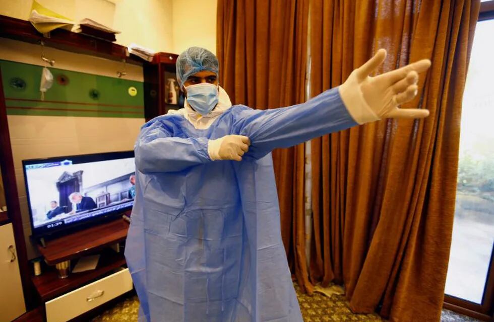An Iraqi doctor wears a protective suit at a center for the coronavirus disease (COVID-19) patients, in the holy city of Kerbala, Iraq July 11, 2020. Picture taken July 11, 2020.  REUTERS/Alaa Al-Marjani