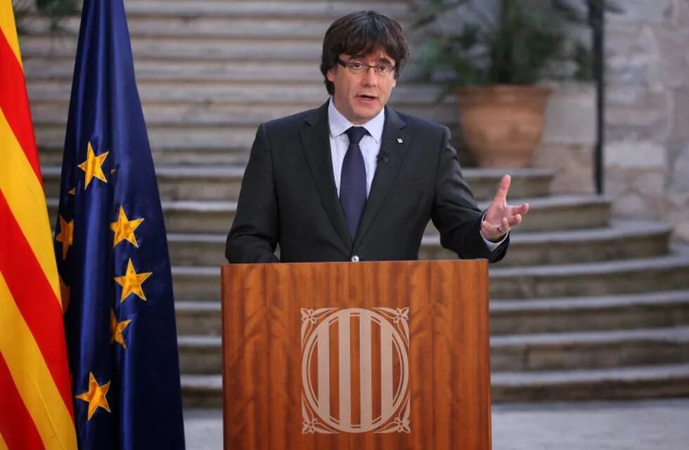 A handout picture released by the Generalitat de Catalunya shows Catalan regional president Carles Puigdemont, who was officially deposed by Madrid, delivering a speech in Girona on October 28, 2017.\nCatalonia's secessionist leader defiantly called for \