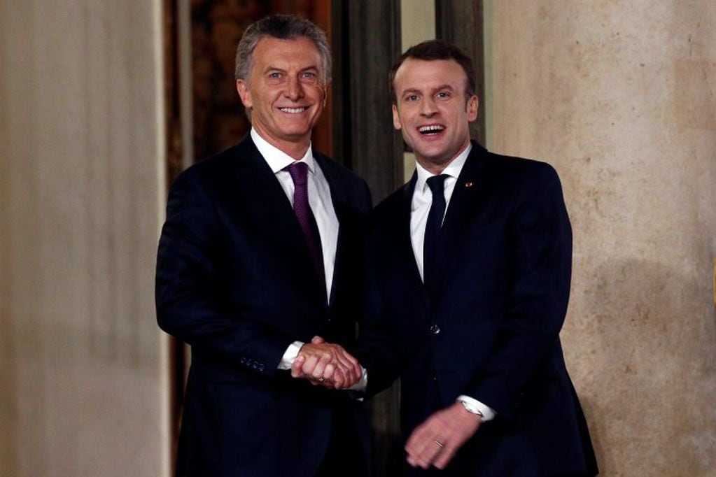France President Emmanuel Macron, right, welcomes President of Argentina Mauricio Macri prior to a meeting, at the Elysee Palace, in Paris, Friday, Jan. 26, 2018. (AP Photo/Thibault Camus)