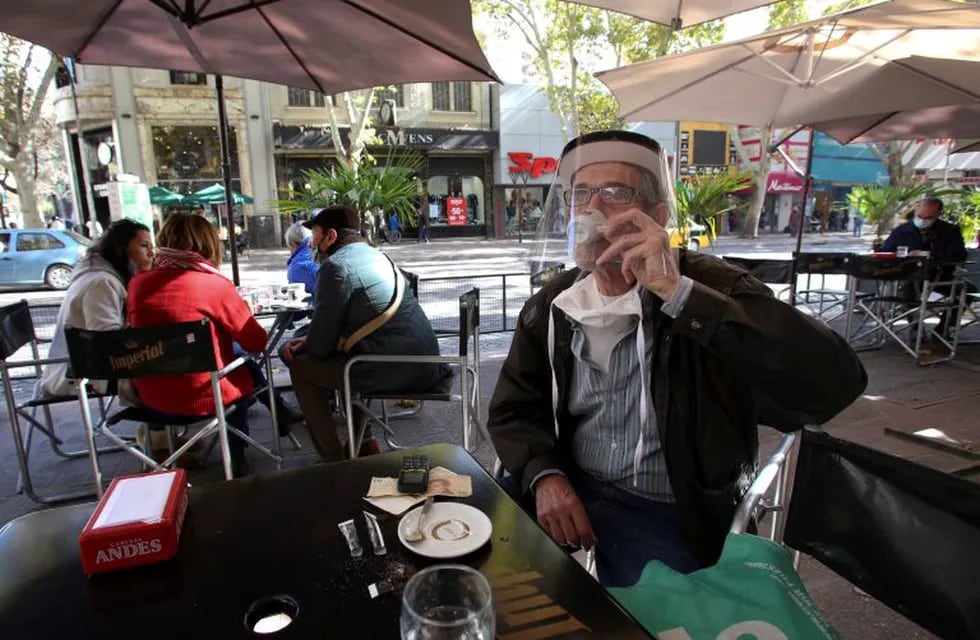 A man wearing a protective face shield drinks coffee as coffee shops reopen following the easing of measures against the spread of the coronavirus disease (COVID-19), in Mendoza, Argentina Mayiano Rios NO RESALES. NO ARCHIVES